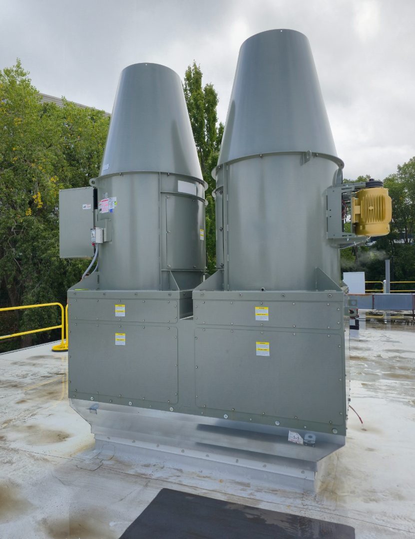 Two completed high-plume exhaust fans on a roof, seen from the side